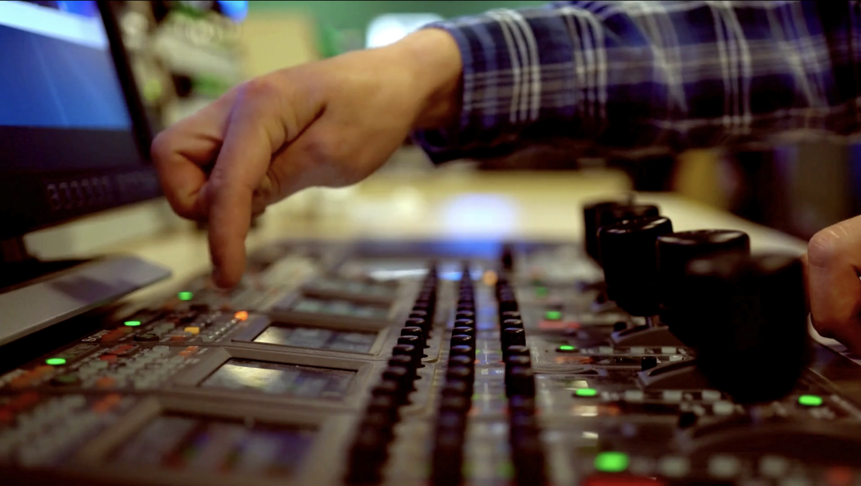 A close up of a hand using a studio desk